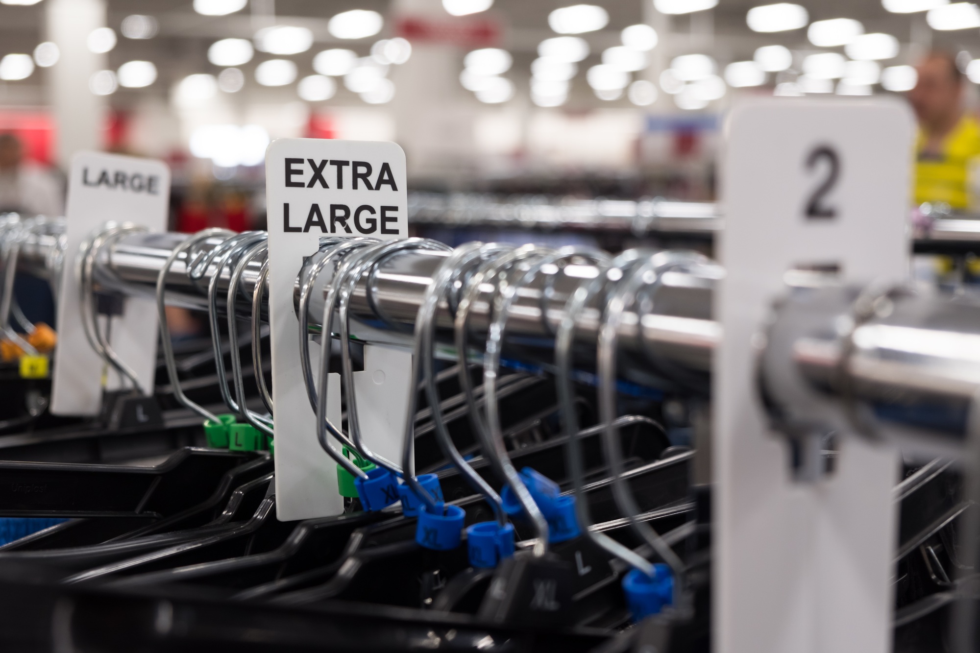 Close up of a clothing rack with extra large clothing size tags