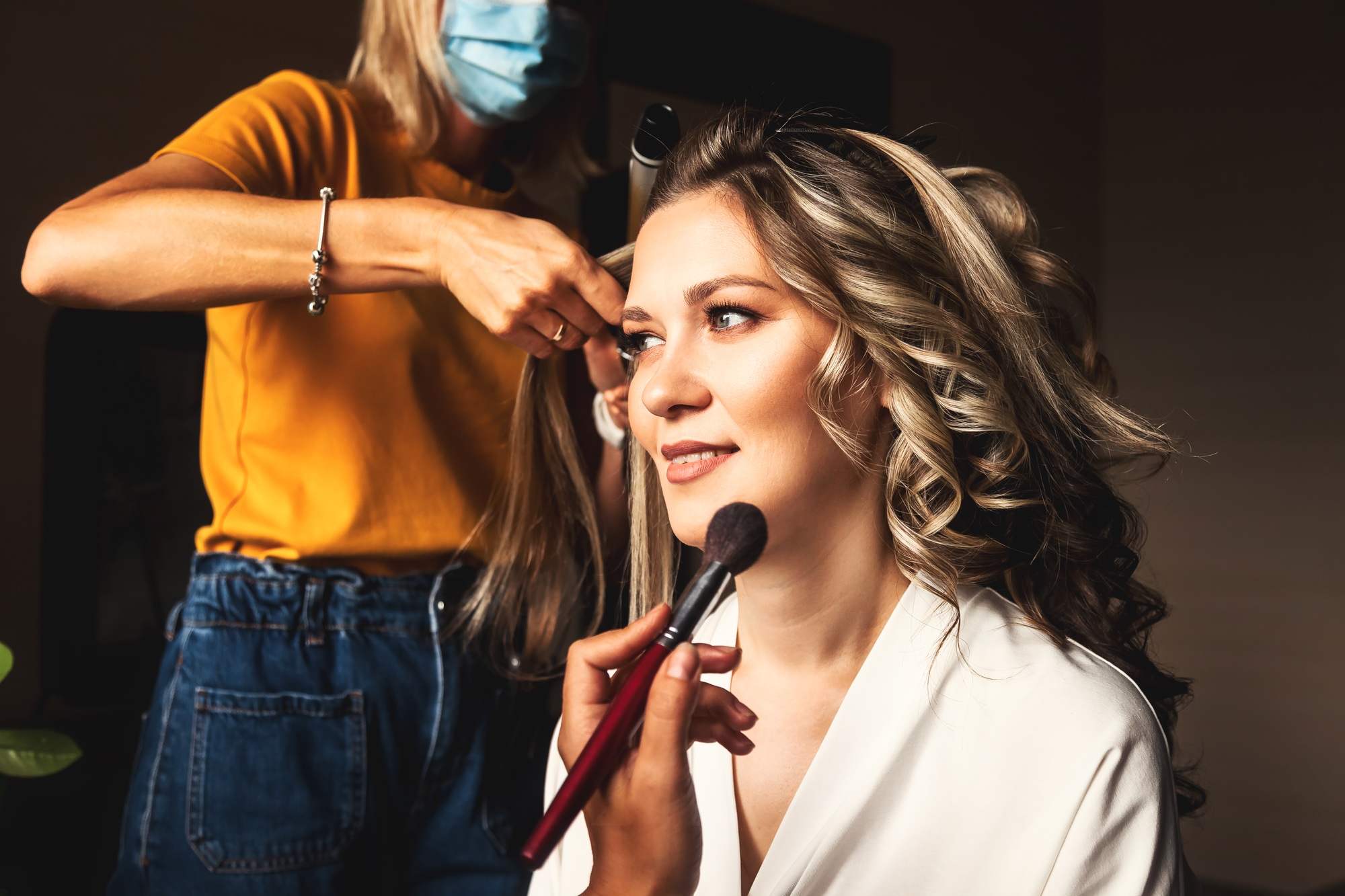 Hairdresser make hairstyle for pretty woman at morning. Make-up artist make wedding makeup